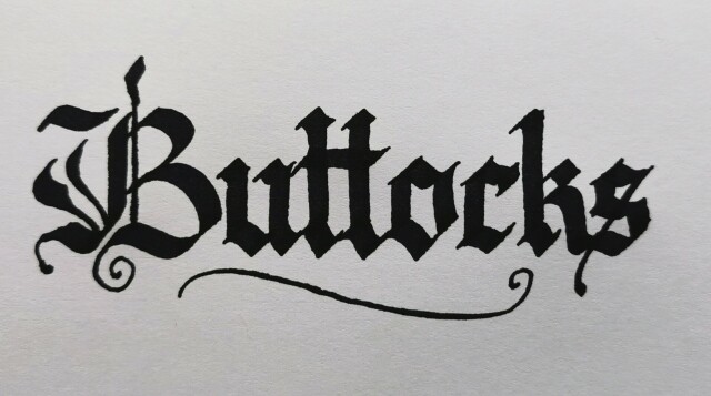 The word "Buttocks" written in black ink in blackletter calligraphy with a fancy majuscule letter B