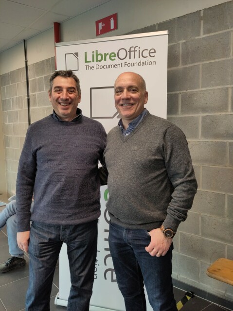 Paolo Vecchi (member of TDF's board of directors) and Stefano Maffulli (Executive Director of the Open Source Initiative) in front of a LibreOffice banner near their booth at FOSDEM