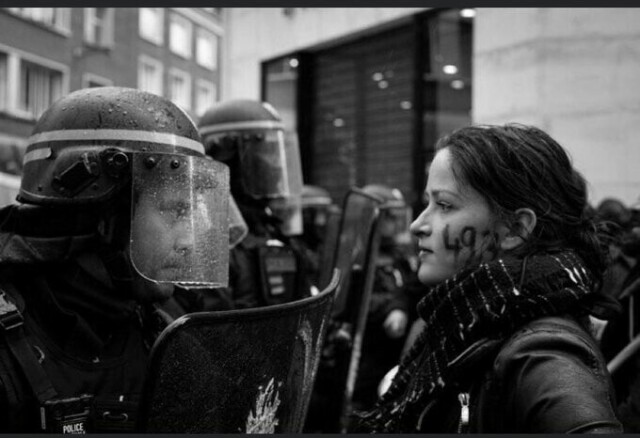 A magnificient black&white photo of a protester in France, a woman with a peaceful yet determined stare (on her cheeck the numbers "49-3", the infamous article of the constitution used by FR gov to bypass the parliament with its unjust pension law). She stares in the eyes of a riot-police man, his face 40cm from hers. Below the visor of his robo-helmet, covered in water, you can see his hard, menacing eyes. This picture pretty much summarizes current state of things in France...

photo credit : Clément Foucard (@ photophoque on Ig)