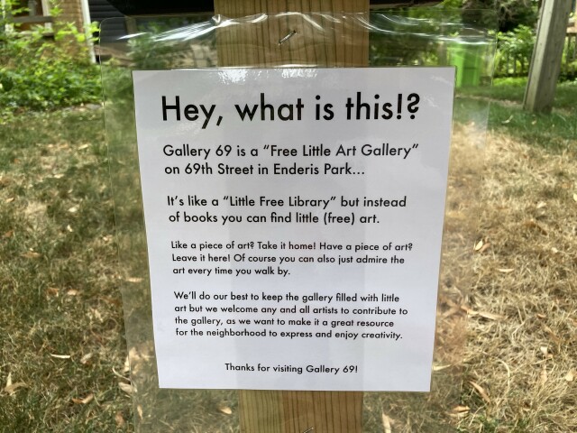 A sign explaining what a free little art gallery is... (Like a library, but for art.)
