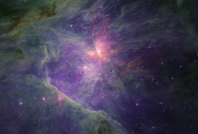 A wide-field image of the inner Orion Nebula & Trapezium Cluster as seen at slightly longer near-infrared wavelengths (2.7-5 microns) by JWST. The image is predominantly purple due to ionised hydrogen & green due to polycyclic aromatic hydrocarbons, but there are regions of brown around the edges due to dust absorption and bright red due to emission from shocked & fluorescent molecular hydrogen. There are thousands of stars, brown dwarfs, & planetary-mass objects strewn across the region, centred on the Trapezium OB stars.