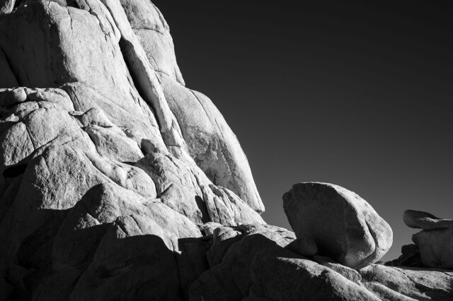 A black and white shot of massive boulders, high contrast in the late afternoon sun