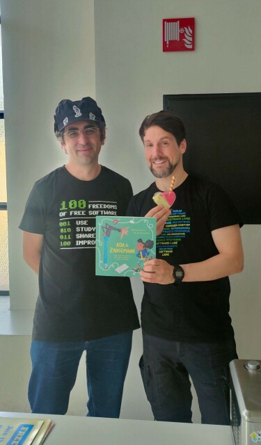 two guys standing next to each other. one holding an Italian book and a heart shaped ice cream.