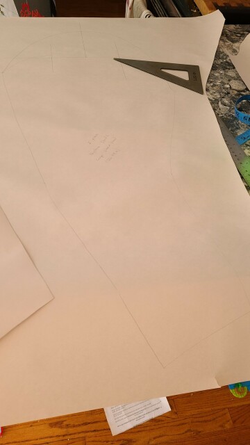 A large piece of paper with a sewing pattern sketched in it.