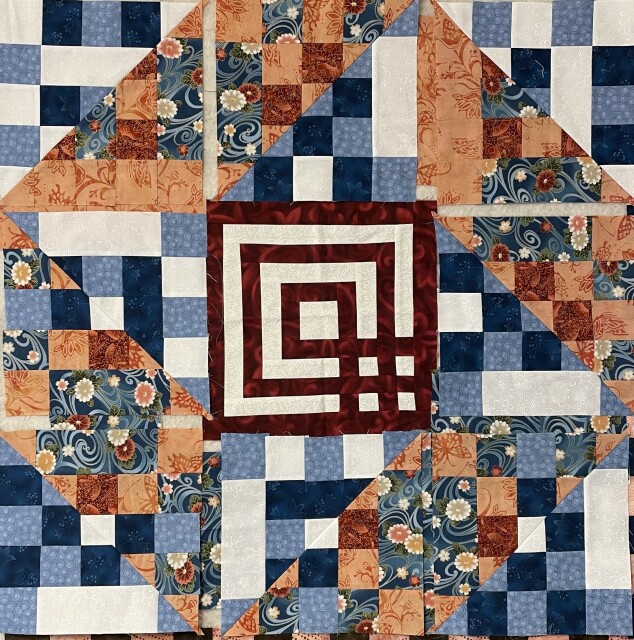 Nine patch made from patchwork triangles with a labyrinth block in the middle