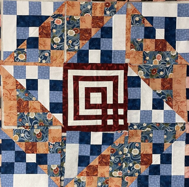 nine patch with patchwork triangles with labyrinth block in the middle