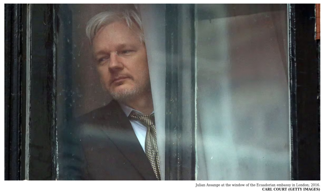 Julian Assange at the window of the Ecuadorian embassy in London; 2016.Carl Court (Getty Images)