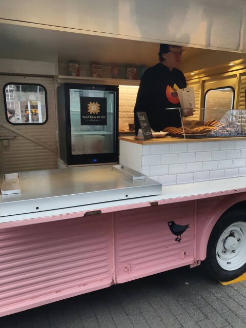 A person with a Firefox shirt in a food truck handing out cookies