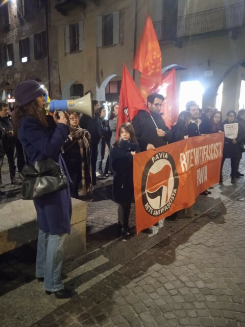 Presidio antifascista con striscione e una donna al megafono.