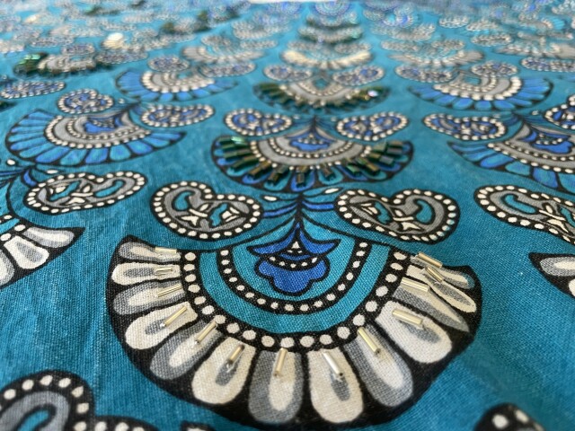 Same kaftan showing closeup of silver bead fan. 